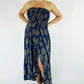 woman wearing a navy blue floral smocked strapless front slit salsa dress 