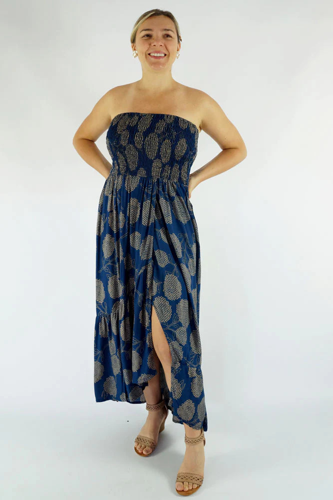 woman wearing a navy blue floral smocked strapless front slit salsa dress 