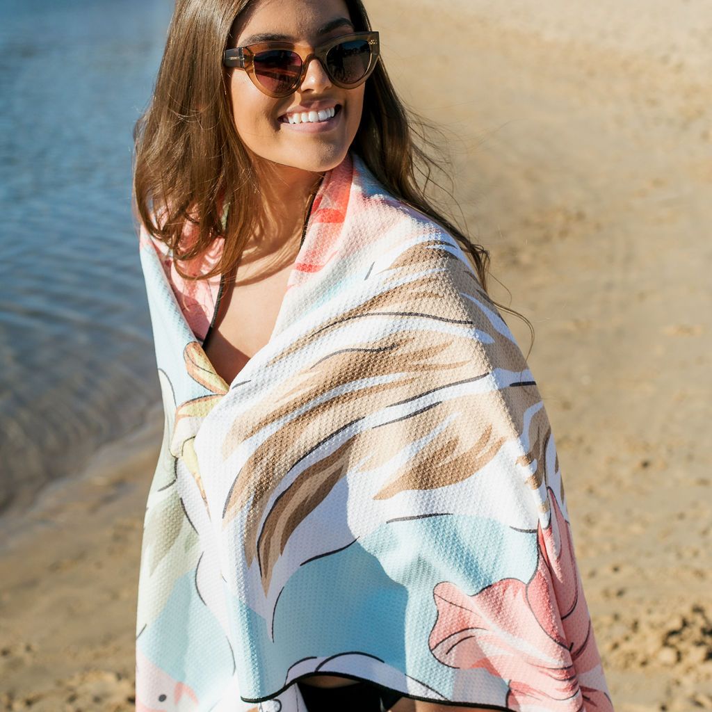 woman on a beach wearing Sand Free Towel - The Byron Flamingo