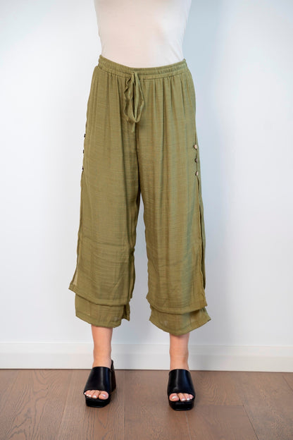 3/4 length loose capri trousers with tie on waist in olive green color with three buttons on the side