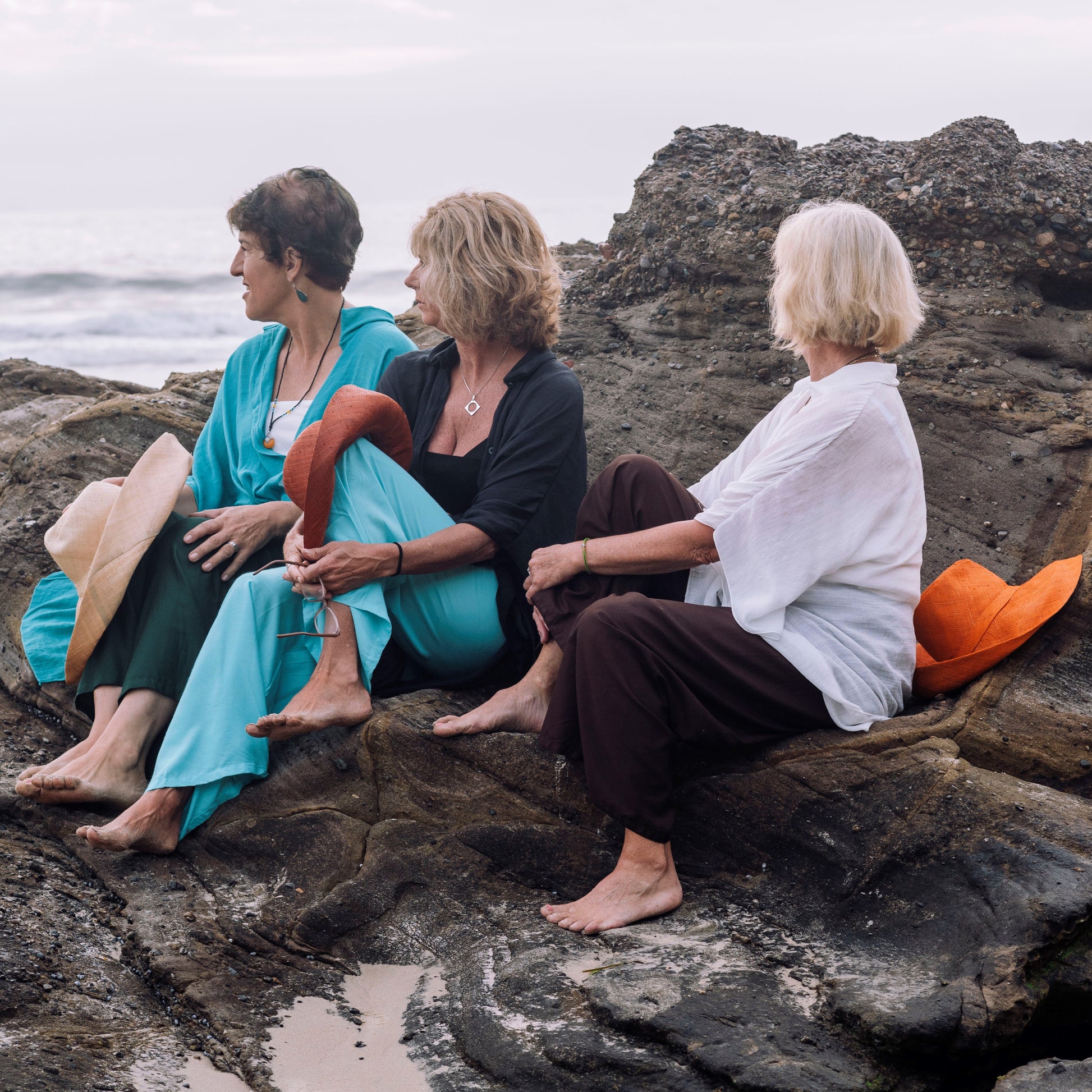 women sitting on the rocks on the beach wearing Palazzo Pants