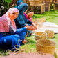 women wearing a Baddara Handmade & Embroidered Linen Scarf making baskets