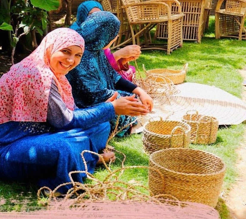 women wearing a Baddara Handmade & Embroidered Linen Scarf making baskets