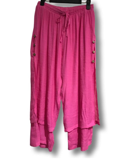 3/4 length loose capri trousers with tie on waist in fuchsia pink color with three buttons on the side