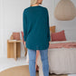 woman wearing emerald freez cape shrug back view