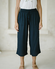 woman wearing a Freez Sicily Shirred Waistband Loose Cropped Trousers with Pockets in ink color