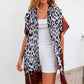 woman wearing jane jungle cape leopard print with brown lining coverup