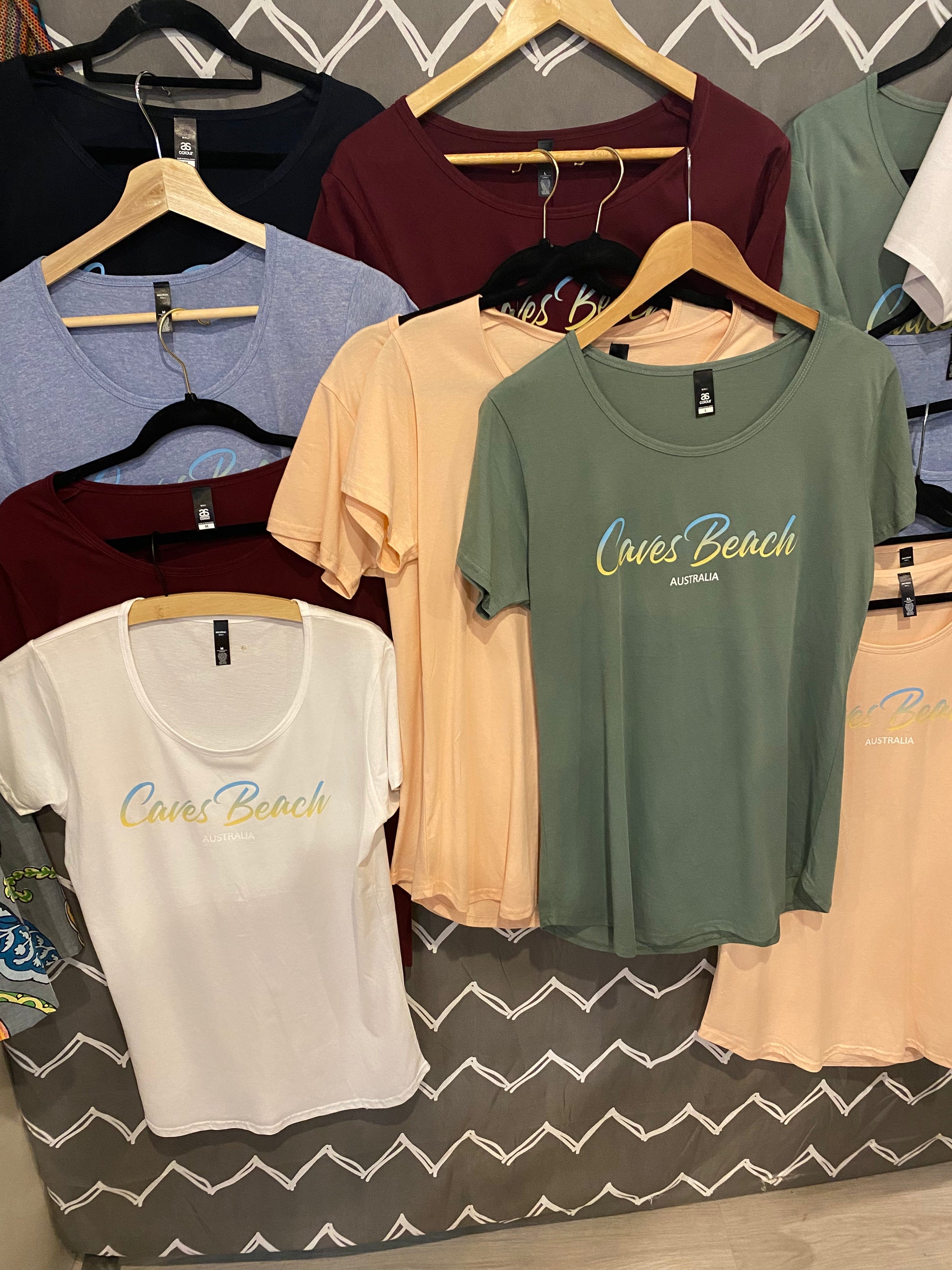 caves beach australia printed t-shirts on a hanger in various colors