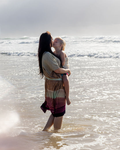 woman wearing Amera Eid Kaftan - Nazli Design with her baby